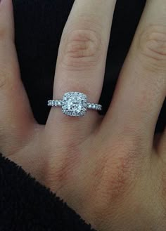 a woman's hand with a diamond ring on it