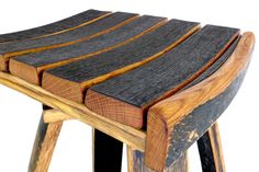 a wooden stool made out of wood and black leather