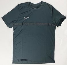 the nike t - shirt is dark green and has a white nike logo on it