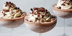 three glasses filled with ice cream and toppings