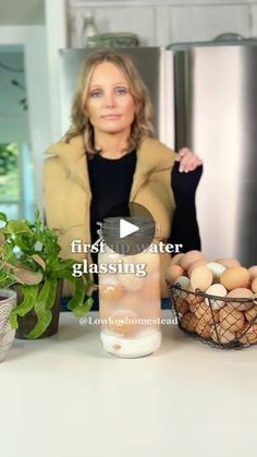 a woman standing in front of a counter filled with eggs