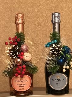 two bottles of wine are decorated with christmas decorations