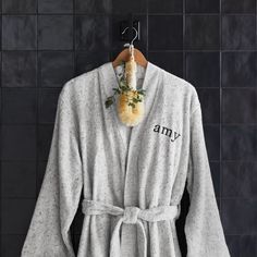 a bathrobe hanging up against a wall with the word army written on it