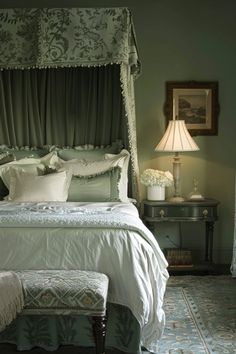 a bedroom with green walls and white bedding