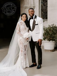 a bride and groom posing for a photo in front of a building