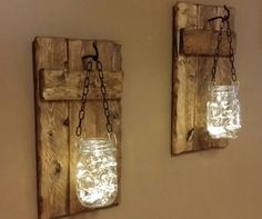 two mason jars are hanging on the wall