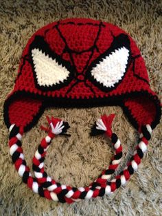 a crocheted spiderman hat with braids on the bottom and ears is shown