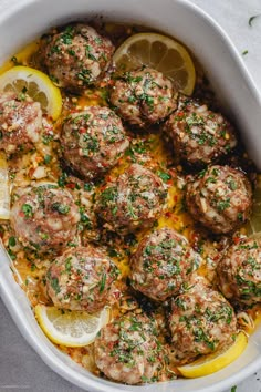 meatballs with lemon and parsley in a white casserole dish