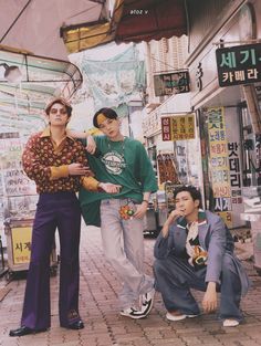 three people standing in front of a store