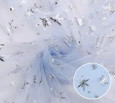 snowflakes and stars on white tulle fabric