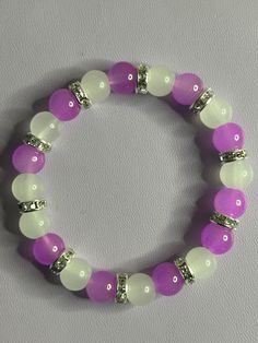 Cute plain purple and white braclet. Purple And White Bracelet, Pink And Purple Bracelet, White Stretch Bracelet With 8mm Beads, White Crystal Bracelet With Colorful Round Beads, White Beaded Round Wristband, Adjustable Purple Wristband With Round Beads, Purple Stretch Bracelet With Colorful Beads, White Beaded Round Bracelets, Purple Bracelet With Colorful Beads