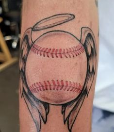 a baseball with an angel's wings on it and a ball in the middle