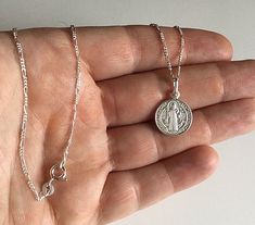 "925 STERLING SILVER SAINT BENEDICT NECKLACE 20\" LONG... FOR GOOD LUCK ,PROSPERITY AND PROTECTION. MADE IN ITALY-BEST QUALITY PENDANT : 24 mm X 15 mm CADENA DE SAN BENITO EN 925 PLATA ESTERLINA 20\" LARGO .. PARA PROSPERIDAD, BUENA SUERTE Y PROTECCION. HECHO EN ITALIA-MEJOR CALIDAD DIJE: 24 mm X 15 mm" Sterling Silver Round Pendant Charm Necklace For Good Luck, Sterling Silver Charm Necklace For Good Luck, White Gold Sterling Silver Charm Necklace, White Gold Sterling Silver Necklace With Charms, Sterling Silver Pendant Charm Necklace For Good Luck, Sterling Silver Engraved Necklace For Good Luck, Silver Hallmarked Necklace, Silver Hallmarked Necklace For Good Luck, Silver Pendant Necklace For Good Luck