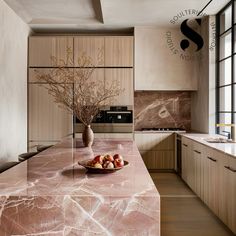 a bowl of fruit sitting on top of a kitchen counter