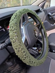 the steering wheel cover is crocheted with green yarn