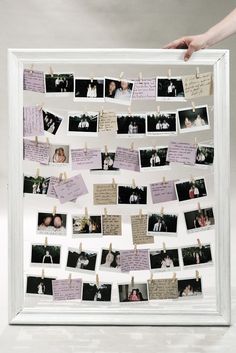 a white frame with pictures and clothes pins attached to it