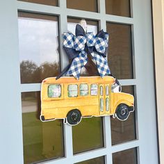 a school bus door hanger with a bow on it