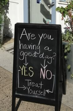 a chalkboard sign that says are you having a good day? yes no treat yourself