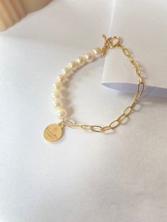 This bracelet is made of freshwater pearl and Paperclip chain. The delicate design and soft colour make it a symbol of tenderness, while the sturdy materials and edgy details add a touch of toughness. Whether you are going for a casual look or dressing up for a special occasion, this bracelet is versatile accessory that will add a unique touch to your style. Freshwater Pearl size is 5mm Paperclip is 14k gold filled Gold Pearl Bracelet In Trendy Style, Everyday Pearl Bracelets With Adjustable Chain, Chic Pearl Bracelet As Gift, Everyday White Chain Bracelet With Pearl Charm, Minimalist Beaded Bracelets With Pearl Chain, Chic Pearl Charm Bracelets As Gifts, Chic Pearl Charm Bracelet As Gift, Elegant Everyday Beaded Bracelets With Chain, Trendy Pearl Chain Bracelet For Gift