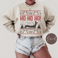 Celebrate the holiday season with our playful Dachshund Ugly Christmas, Unisex Gildan 180 sweatshirt! This festive design features a charming doxie dog in a pixelated Christmas theme, capturing the spirit of the season in a unique, retro style. Perfect for dog lovers and Christmas enthusiasts alike, this sweater will add a touch of fun and warmth to your holiday wardrobe. .: 50% cotton, 50% polyester  .: Medium-heavy fabric (8.0 oz/yd² (271.25 g/m .: Loose fit  .: Sewn-in label  .: Runs true to Winter Crew Neck Top With Dog Print, Winter Dog Print Crew Neck Top, Doxie Dog, Doxie Mom, Washing And Drying Machine, Mom Sweater, Gift For Dog Lover, Dad Gifts, Festive Design