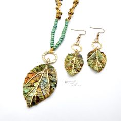 Fun and lightweight boho jewelry pendant necklace and earring set features handpainted, realistic and textured leaves made with polymer clay and resin. The pendant hangs on a knotted macrame cord accented with irregular colored seed beads - perfect to wear with your favorite  t- shirts or casual outfits! Let's welcome spring and summer with these whimsical, boho chic accessories. The clay beads are hand painted, baked, sanded, buffed, and sealed with resin for protection.  Findings: plated metal Boho Chic Accessories, Boho Texture, Mom Friend, Macrame Cord, Leaf Necklace, Jewelry Pendant, Chic Accessories, Wedding Jewelry Sets, Clay Beads