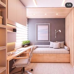 a room with a bed, desk and chair next to a book shelf filled with books