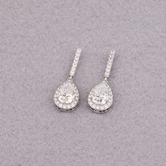 "Are you tired of looking for stunning earrings for your special day? These elegantly designed cubic zirconia teardrop earrings will be your best choice! The length of the earring is about 1 1/8\" (2.9cm). These gorgeous earrings are perfect for a wedding, the bride, the bridesmaids, wedding parties or any special occasion. Specifications: Earring Length about: 1 1/8\" (2.9cm) Teardrop about: 1/2\"H x 3/8\"W (1.5cm x 1cm) They will be available in silver, rose gold or gold finish. Any questions? Elegant Bridal Teardrop Pendant Earrings For Wedding, Wedding Teardrop Pendant Earrings For Pierced Ears, Elegant Teardrop Pendant Earrings For Wedding, Elegant Bridal Earrings With Teardrop Pendant For Gift, Elegant Bridal Earrings With Teardrop Pendant, Elegant Bridal Teardrop Pendant Earrings, Silver Teardrop Pendant Earrings For Wedding, Bridal Drop Earrings With Halo Design, Halo Design Bridal Drop Earrings