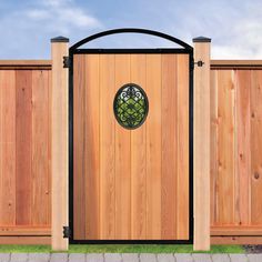 a wooden gate with a circular window in the center and side panels on each side