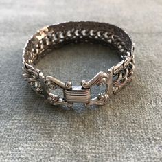 "This bracelet has some weight to it. The curb chain at the center is flanked by snake chains which are soldered to it so the piece moves as a sinuous whole. The clasp belies the more modernist look of the chain, with it's lyre shaped finials holding the fold over closure. The piece measure 7 3/4\" long by 3/4\" wide.  I'm happy to ship internationally but costs have risen so dramatically I can no longer ship worldwide for $12. If you are outside of the US and want to make a purchase. Let me kno Elegant Metal Cuban Link Bracelet With Curb Chain, Metal Cuban Link Bracelet With Curb Chain, Cuban Link Bracelet With Curb Chain In Metal, Elegant Adjustable Cuban Link Metal Bracelet, Adjustable Metal Jewelry With Curb Chain, Metal Box Chain Link Bracelet, Elegant Cuban Link Metal Bracelets, Adjustable Metal Curb Chain Jewelry, Sterling Silver Jubilee Link Bracelet