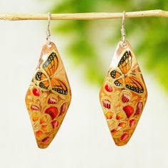 Add a touch of springtime joy to your looks with this colorful set of dangle earrings by Rosy and Daniel. They're crafted from copper and hand-painted with monarch butterflies and floral motifs in gold orange moss green and carnation. Artistic Hand Painted Copper Earrings, Hand Painted Jewelry As Spring Gift, Hand Painted Jewelry For Spring Gift, Hand Painted Copper Bohemian Earrings, Hand Painted Artsy Copper Earrings, Hand Painted Copper Artsy Earrings, Bohemian Hand Painted Copper Earrings, Artsy Hand Painted Copper Earrings, Spring Multicolor Hand-painted Jewelry