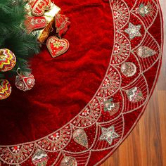 a christmas tree skirt with ornaments on it