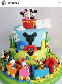 a mickey and minnie mouse birthday cake is shown