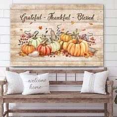 a wooden bench sitting in front of a wall with pumpkins and leaves on it