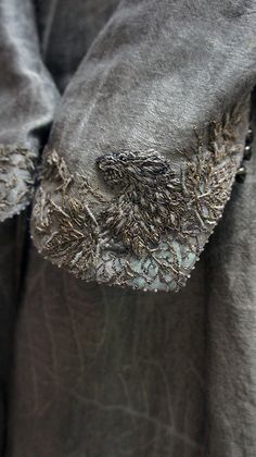 a close up of a person's shirt with buttons and holes in the fabric