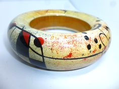 "Vintage Wood Bangle. Chunky Rounded Bracelet. Inspired by Miro. Killer Design. High Quality. Opening: 2.5\" Thickness / width: 1 inch Wall Width: 3/4\" I don't know much about the origins of this fantastic bangle. It appears to be hand painted, and varnished. It has a nice hefty weight, and appears to be of a very high quality. Nicely done, with stars, squiggles, dots and lines, in primary colors of red & blue, with black. Circa 1980s or 90s. Light surface wear, overall very nice condition. Bracelet Inspired, Plastic Bangles, Military Photos, Gorgeous Bracelet, Chicago Il, Vintage Wood, Vintage Collection, Red Color, Primary Colors