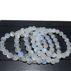 a bunch of white beads sitting on top of a wooden table