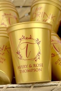 several gold cups with the names avery and rose on them are sitting in a wicker basket