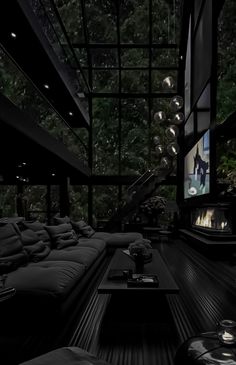 a living room filled with lots of black furniture