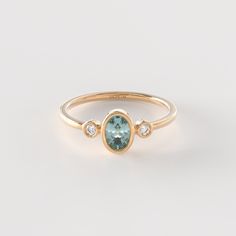 𝟏𝟒𝐤 𝐒𝐨𝐥𝐢𝐝 𝐆𝐨𝐥𝐝 𝐎𝐯𝐚𝐥 𝐓𝐞𝐚𝐥 𝐒𝐚𝐩𝐩𝐡𝐢𝐫𝐞 𝐑𝐢𝐧𝐠 The Diamond Teal Sapphire Bezel Ring is a stunning piece of handmade jewelry crafted in 14k solid gold. Featuring a small oval blue sapphire in a delicate bezel setting, this ring is a beautiful and unique statement of elegance. The addition of diamonds adds a touch of sparkle and sophistication to the design. Perfect as a promise ring or a dainty accessory, this handmade piece is a thoughtful and stylish gift for someone spe Sapphire Ring White Gold, Oval Sapphire Diamond Ring With Bezel Setting, Oval 14k Gold Rings With Bezel Setting, Fine Jewelry Sapphire Ring With Bezel Setting, Oval Topaz Ring With Bezel Setting For Anniversary, Oval Topaz Ring In 14k Gold With Bezel Setting, Oval Sapphire Ring With Bezel Setting For Anniversary, Oval Sapphire Promise Ring With Bezel Setting, Fine Jewelry Oval Topaz Ring With Bezel Setting