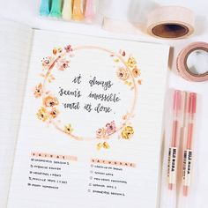 an open notebook with writing on it next to some markers and washi tapes