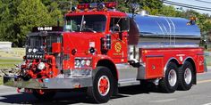 a red fire truck driving down the road