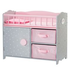 a pink and grey baby crib bed with three drawers on the bottom, and polka dot lining