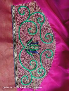 a pink and green cloth with an embroidered bird on it's side, in the middle