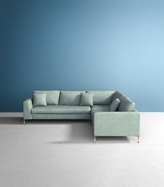 a blue couch sitting on top of a white floor