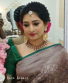 a woman in a green and gold sari