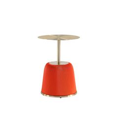 an orange table with a metal base and round design on the top, against a white background