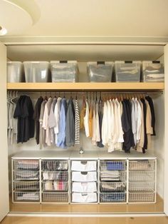 an organized closet with clothes and bins