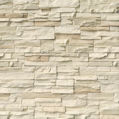 a stone wall that looks like it has been made out of white and tan bricks