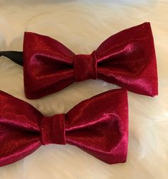 "Gorgeous Burgandy Satin Bow Tie These bow tie has been design in japones satin. The Unisex bow ties are an excellent evening addition to any wardrobe. You will look unique at any special occasion. Our bow ties are made in fine satin with interfacing to give it, stability and shape. Approximate Measurements: Bow: 5\" x 2.5\" Adjustable Strap: 14\" x 19\" Bow Tie care recommended Dry Clean only. All items are sent Via USPS First Class Mail within the U.S. shipping times take an average of 5-7 Bus Red Bow Tie For Party, Red Bow Standard Bow Tie For Party, Red Standard Tie For Wedding, Red Standard Tie For Wedding Suit, Red Adjustable Tie For Wedding, Adjustable Red Ties For Wedding, Red Wedding Tie And Suit Accessories, Adjustable Red Suit And Tie Accessories For Wedding, Red Adjustable Ties For Weddings