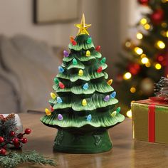 a small christmas tree sitting on top of a wooden table